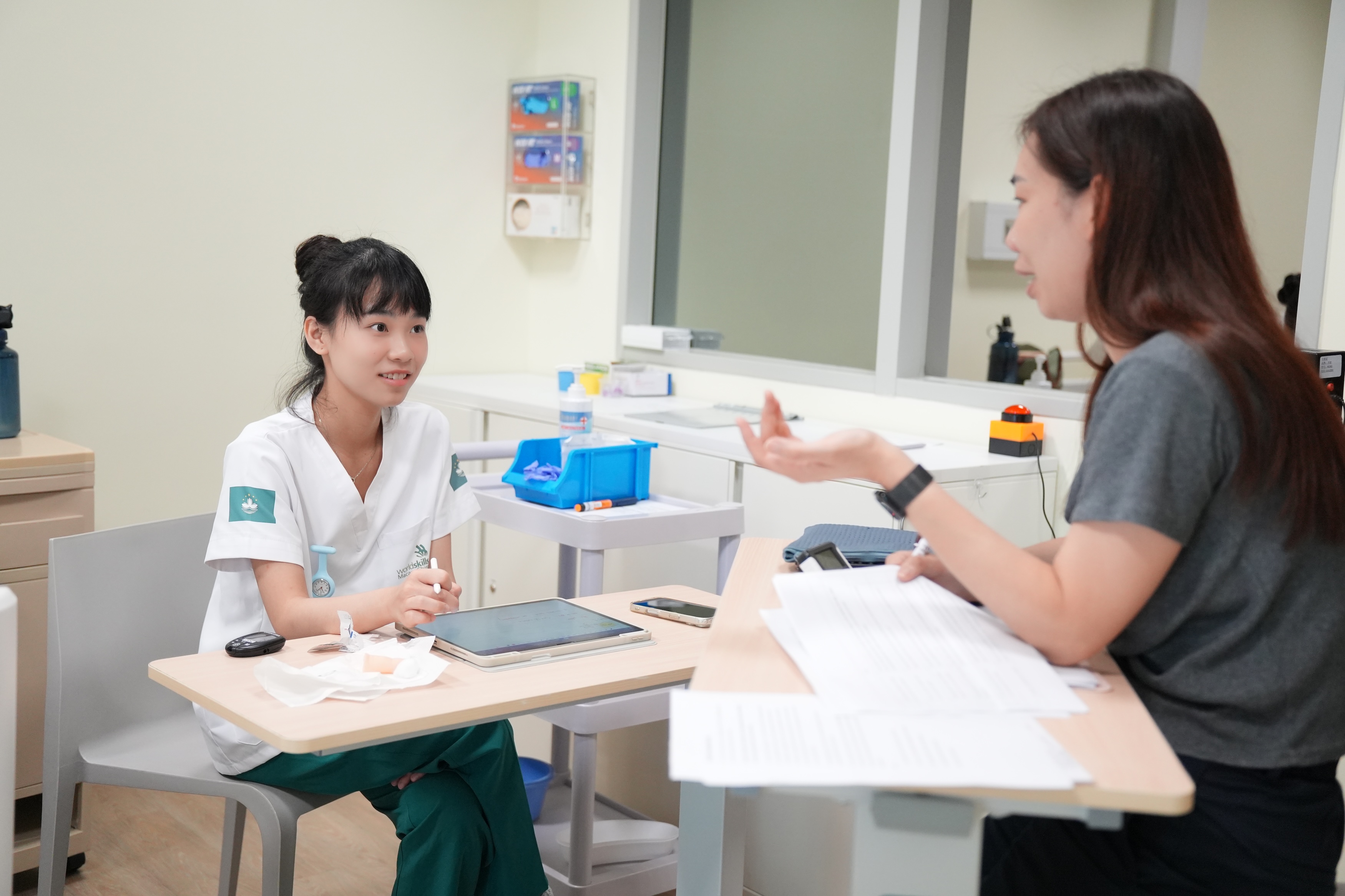 ▲ Lecturer Hung Tan, right, is appointed as an expert for the Health and Social Care skill competition